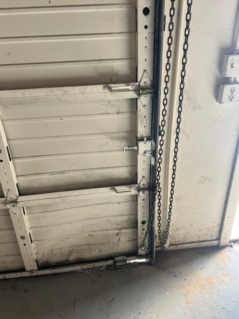 Inside view of a sectional garage door with its track and opener chain