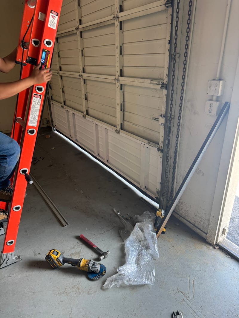 Garage door with a damaged section being replaced